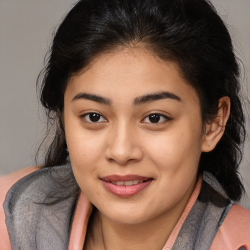 Joyful latino young-adult female with long  brown hair and brown eyes