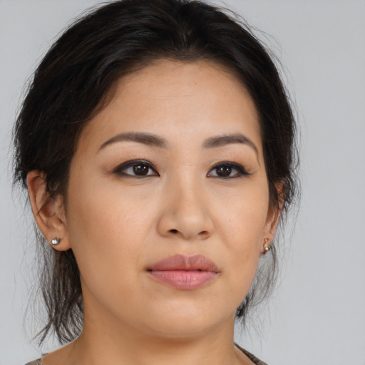 Joyful asian young-adult female with medium  brown hair and brown eyes