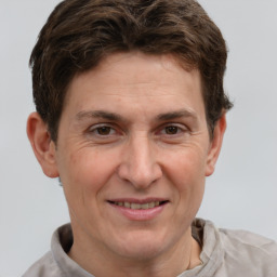 Joyful white adult male with short  brown hair and grey eyes