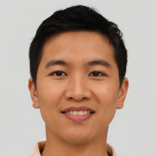 Joyful asian young-adult male with short  brown hair and brown eyes