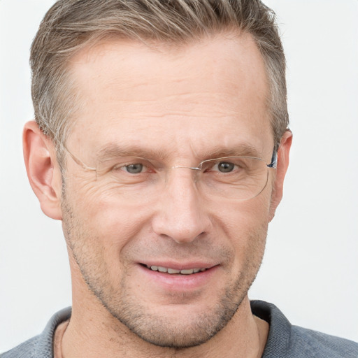 Joyful white adult male with short  brown hair and grey eyes