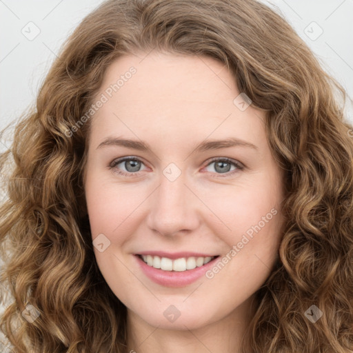 Joyful white young-adult female with long  brown hair and green eyes