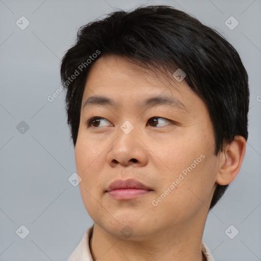 Joyful asian young-adult male with short  brown hair and brown eyes