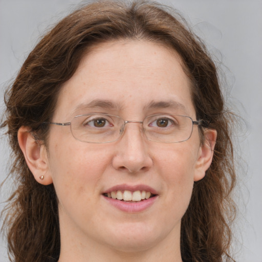 Joyful white adult female with medium  brown hair and grey eyes