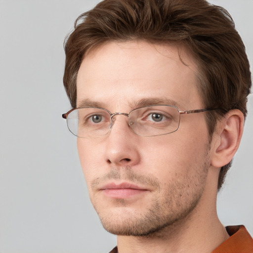 Joyful white adult male with short  brown hair and grey eyes