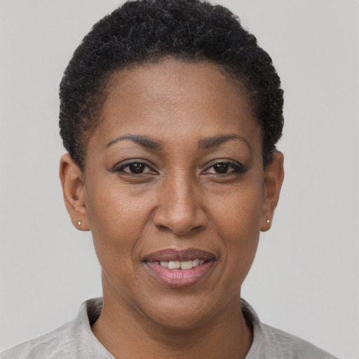 Joyful black adult female with short  black hair and brown eyes