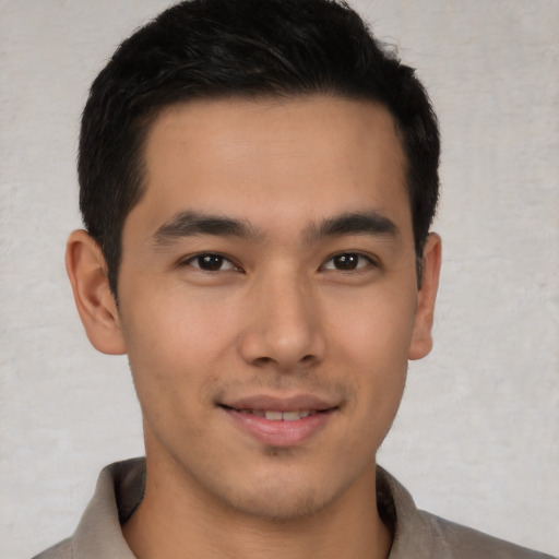 Joyful latino young-adult male with short  brown hair and brown eyes