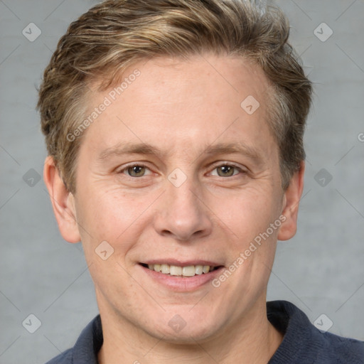 Joyful white adult male with short  brown hair and grey eyes