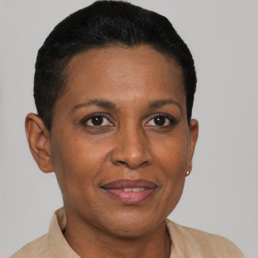 Joyful latino adult female with short  brown hair and brown eyes