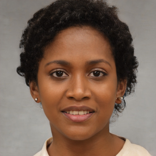 Joyful black young-adult female with short  brown hair and brown eyes
