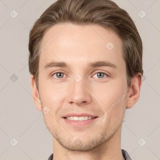 Joyful white young-adult male with short  brown hair and grey eyes