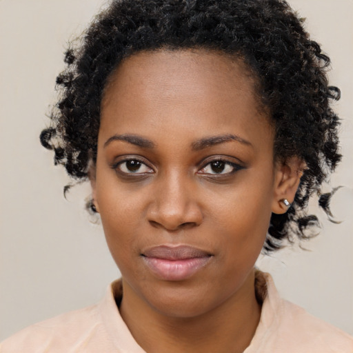 Joyful black young-adult female with medium  black hair and brown eyes