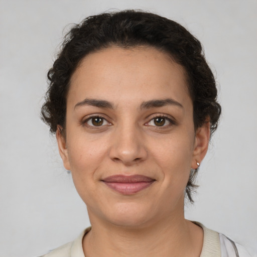 Joyful latino young-adult female with short  brown hair and brown eyes