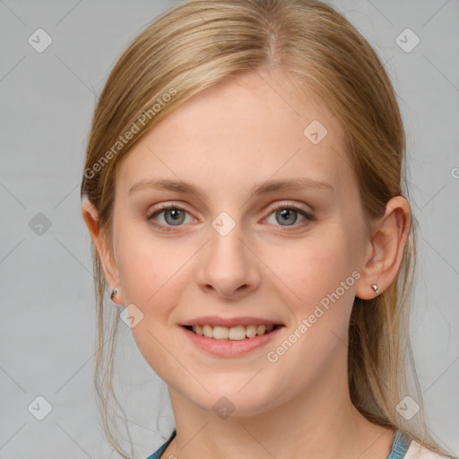 Joyful white young-adult female with medium  brown hair and blue eyes