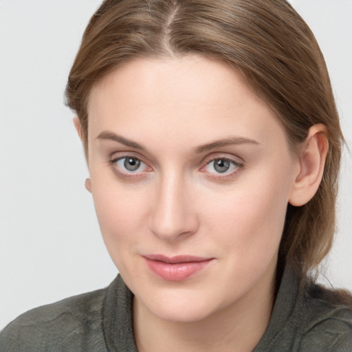 Joyful white young-adult female with long  brown hair and blue eyes