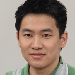 Joyful asian young-adult male with short  black hair and brown eyes