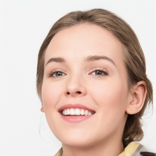 Joyful white young-adult female with medium  brown hair and blue eyes