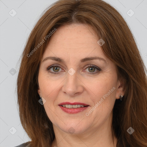 Joyful white adult female with long  brown hair and brown eyes