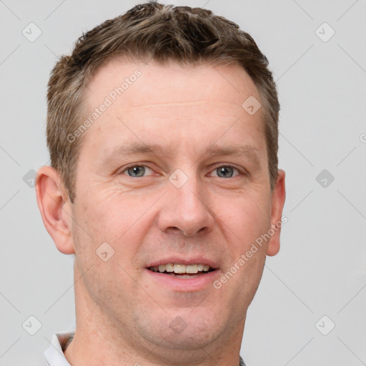 Joyful white adult male with short  brown hair and grey eyes