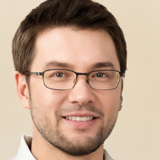 Joyful white young-adult male with short  brown hair and grey eyes