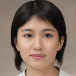 Joyful asian young-adult female with medium  black hair and brown eyes