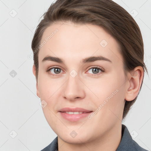 Joyful white young-adult female with short  brown hair and grey eyes