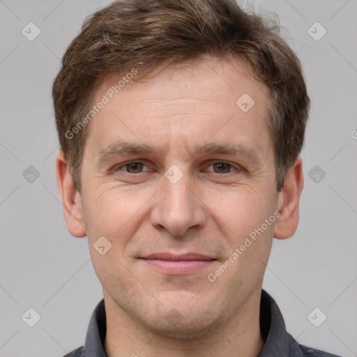 Joyful white adult male with short  brown hair and grey eyes