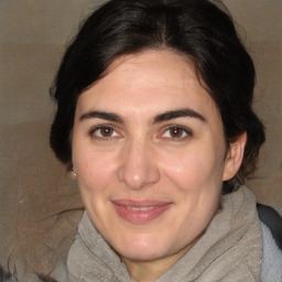 Joyful white adult female with medium  brown hair and brown eyes