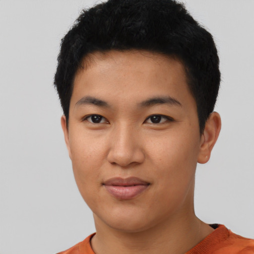 Joyful asian young-adult male with short  black hair and brown eyes