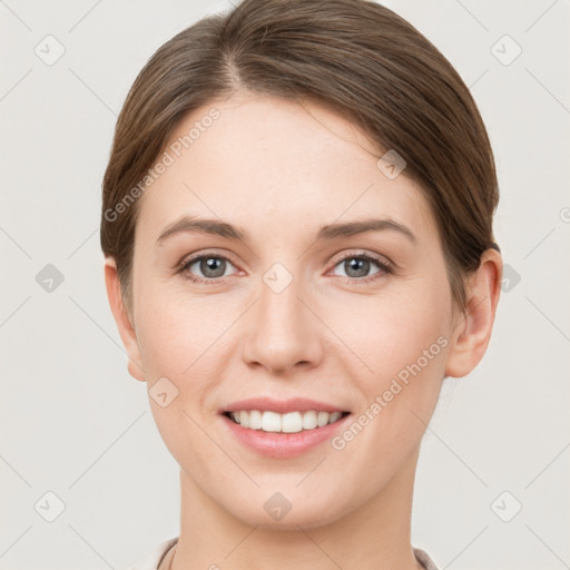 Joyful white young-adult female with short  brown hair and grey eyes