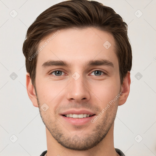 Joyful white young-adult male with short  brown hair and grey eyes