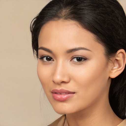 Joyful latino young-adult female with long  brown hair and brown eyes