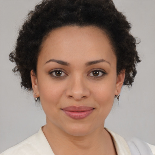 Joyful black young-adult female with medium  brown hair and brown eyes