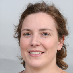 Joyful white young-adult female with medium  brown hair and blue eyes