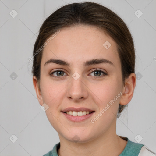 Joyful white young-adult female with medium  brown hair and grey eyes