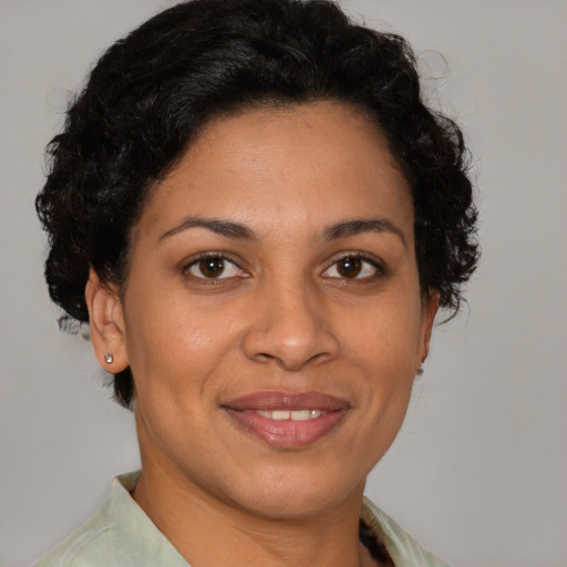 Joyful latino adult female with short  brown hair and brown eyes