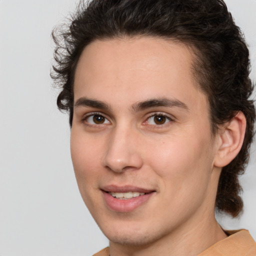 Joyful white young-adult male with medium  brown hair and brown eyes