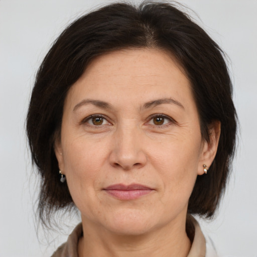 Joyful white adult female with medium  brown hair and brown eyes