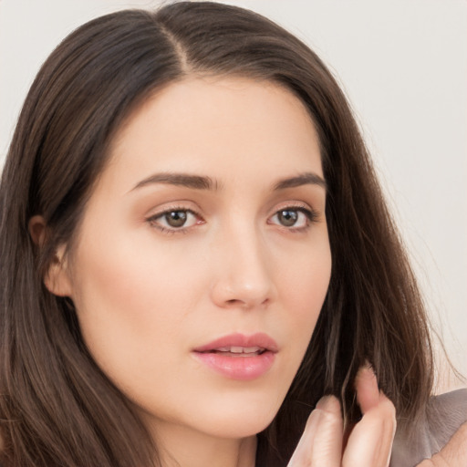 Neutral white young-adult female with long  brown hair and brown eyes