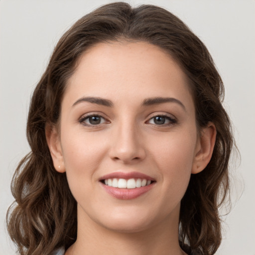 Joyful white young-adult female with long  brown hair and grey eyes