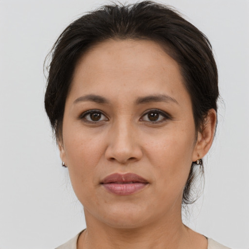 Joyful asian adult female with medium  brown hair and brown eyes