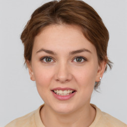 Joyful white young-adult female with short  brown hair and grey eyes