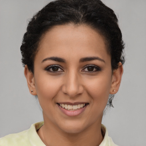 Joyful latino young-adult female with short  brown hair and brown eyes