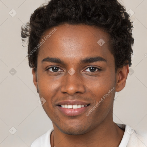 Joyful black young-adult male with short  brown hair and brown eyes