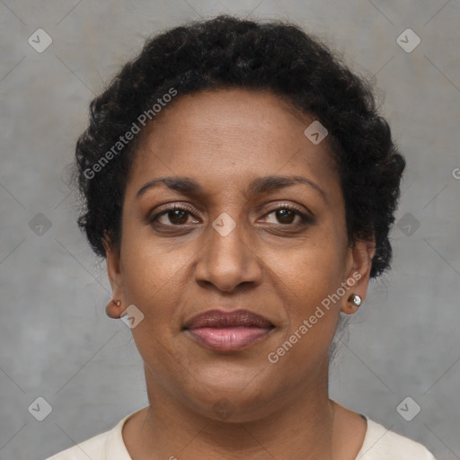 Joyful black adult female with short  brown hair and brown eyes