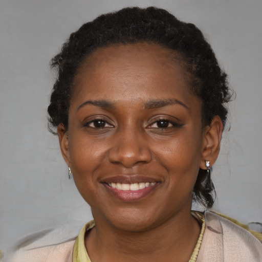 Joyful black young-adult female with short  brown hair and brown eyes