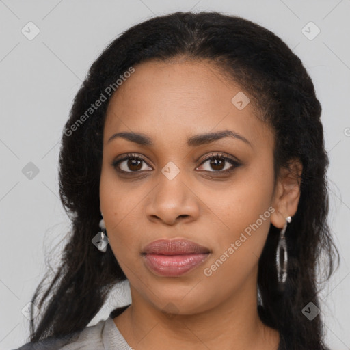 Joyful black young-adult female with long  black hair and brown eyes