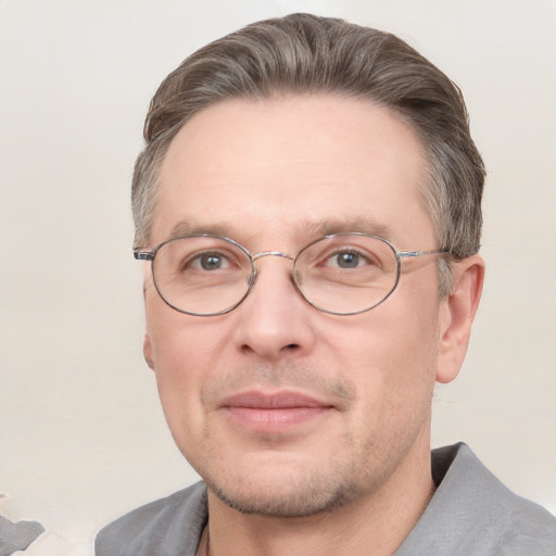 Joyful white adult male with short  brown hair and grey eyes