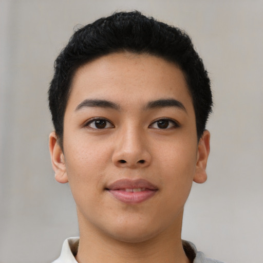 Joyful asian young-adult male with short  black hair and brown eyes