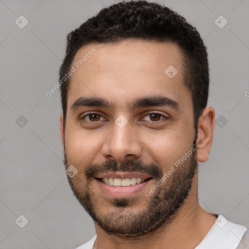 Joyful white young-adult male with short  black hair and brown eyes